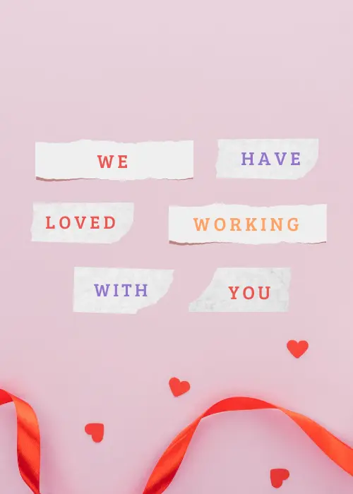Soft pink card with torn paper strip cutouts reading "WE HAVE LOVED WORKING WITH YOU" in multicolored red, purple, and orange typewriter-style letters arranged across the card, with small red hearts and a red ribbon curled at the bottom