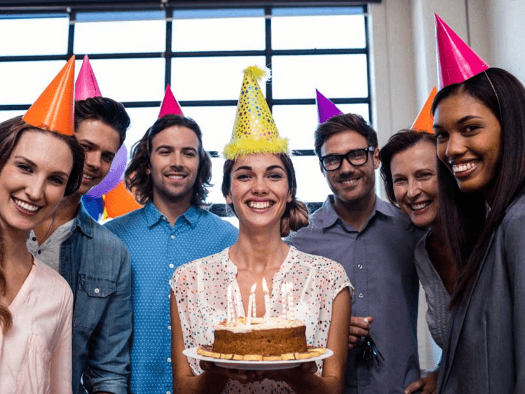 Coworkers birthday being celebrated at the office